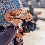 A young woman capturing moments with her camera in sunny İstanbul.